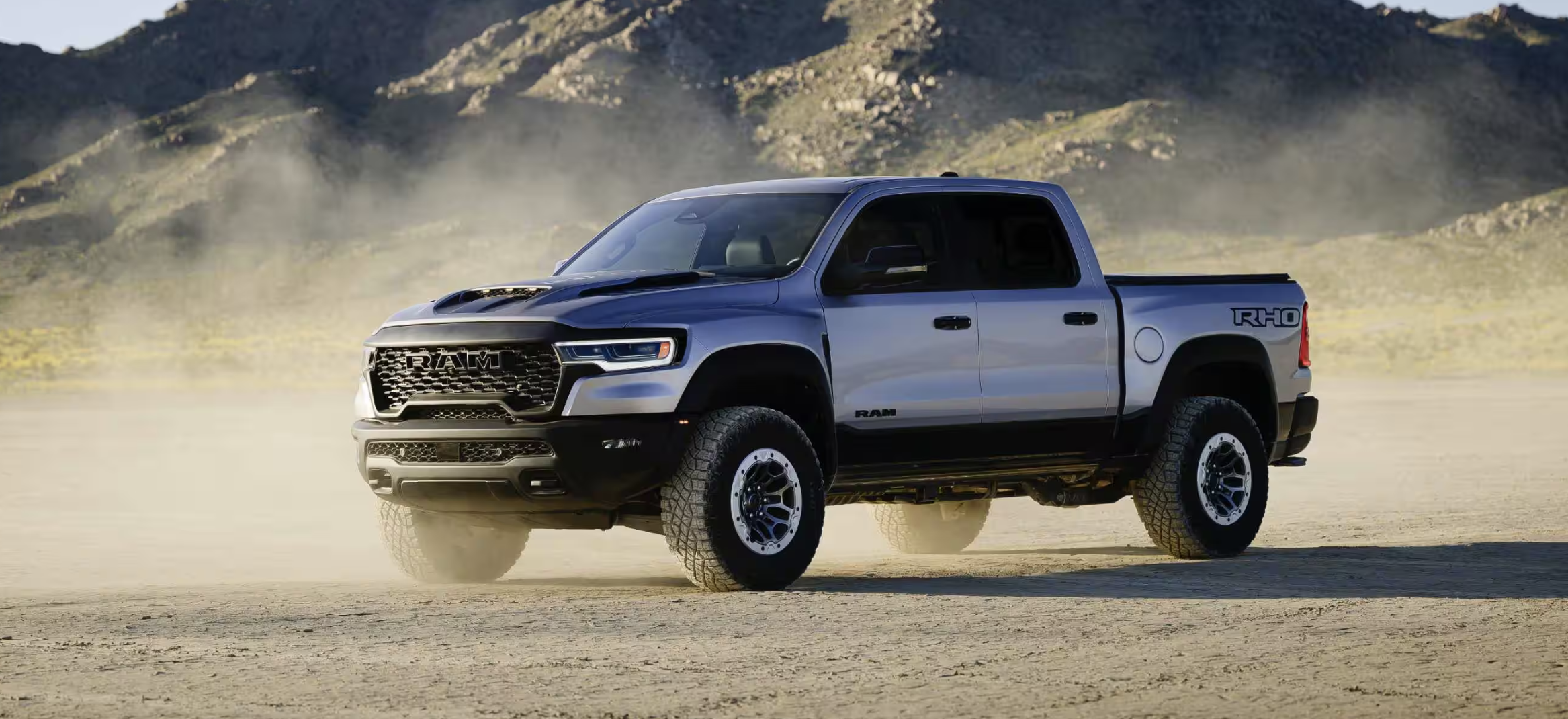 2025 RAM 1500 RHO pickup truck kicking up dust